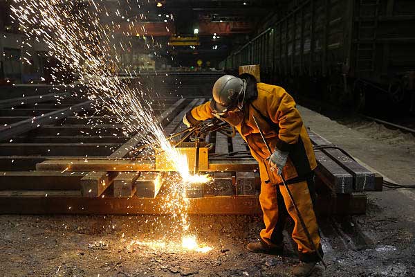 Man welding square bars